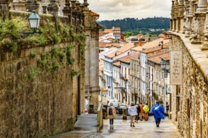 A vibrant and charming street in a historic European town, bustling with people and character.